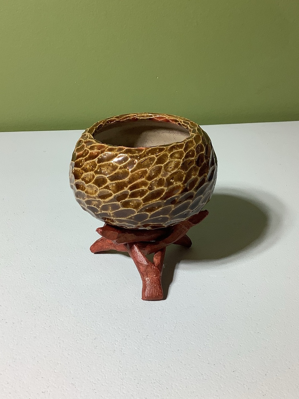 Pottery bowl on wooden “puzzle” stand